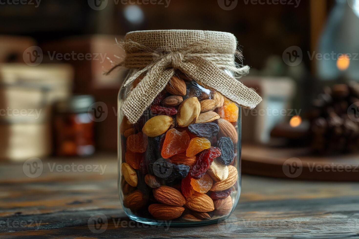 Glass jar filled with healthy nuts and dried fruits rests on rustic wooden table photo