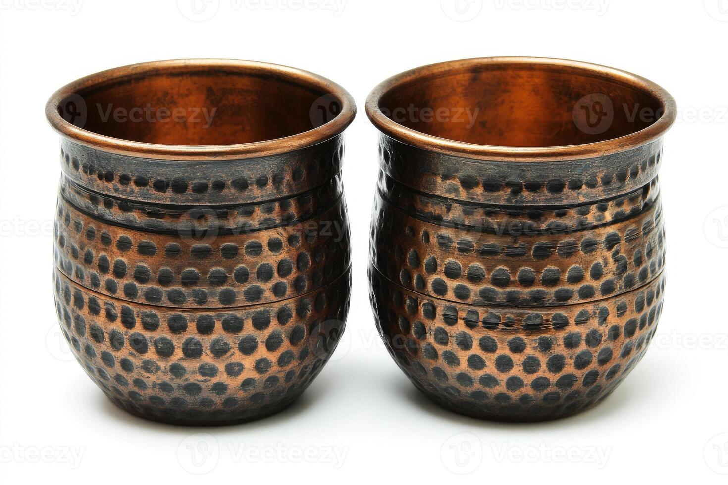 Two hammered copper cups standing on white background photo