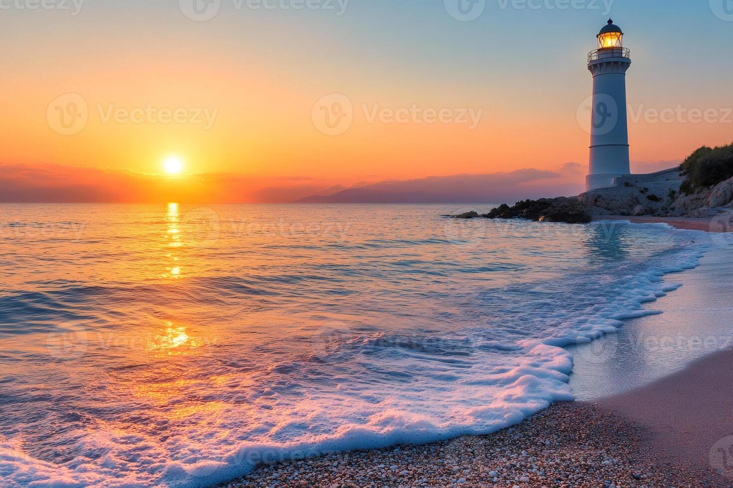 Lighthouse shining at sunset on a beautiful beach with waves crashing photo