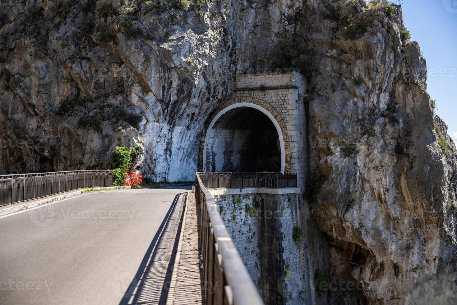 The road and tunnel on sunny day of the Amalfi Coast, Mediterranean, Italy. photo