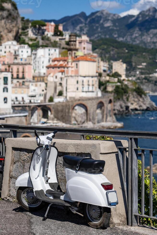 White scooter with background of Amalfi Coast, Italy. photo