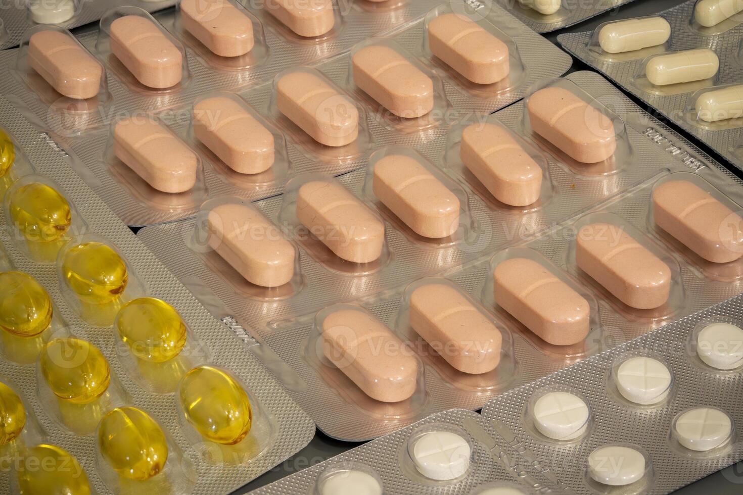 Collection of assorted pills and capsules arranged in packaging photo