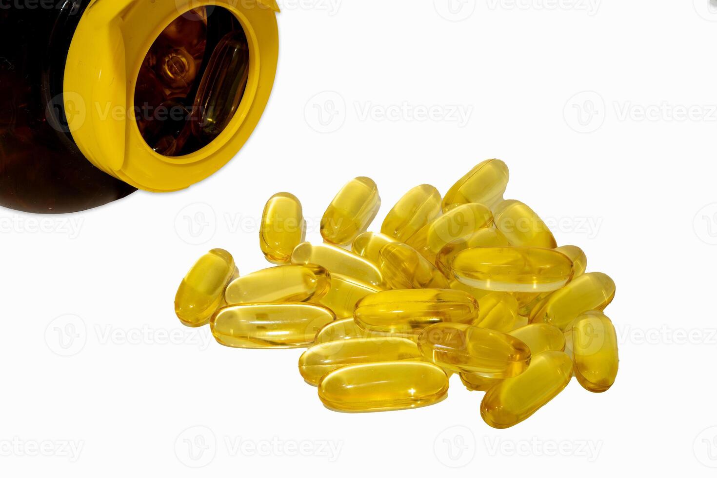 Softgel capsules spill from a bottle on a white surface photo