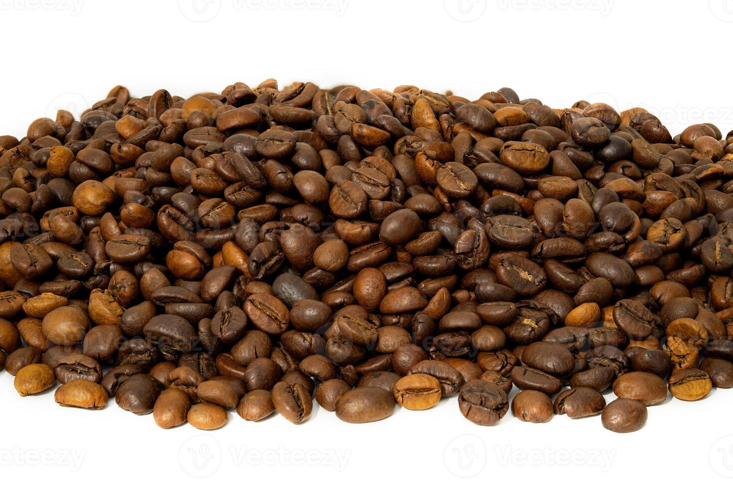 Freshly roasted coffee beans piled high on a white background photo