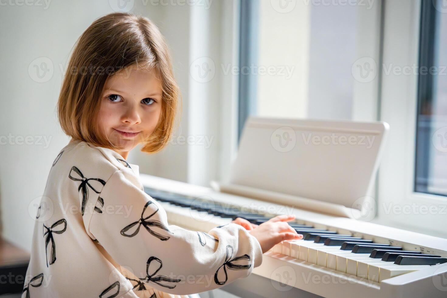 Home lesson on music for the girl on white piano synthesizer. Concept of early development. learning music enhances motor skills, hearing, and intelligence, fostering creativity from childhood. photo