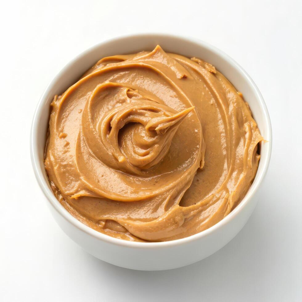 Top View of Creamy Peanut Butter in a Bowl on a White Background photo