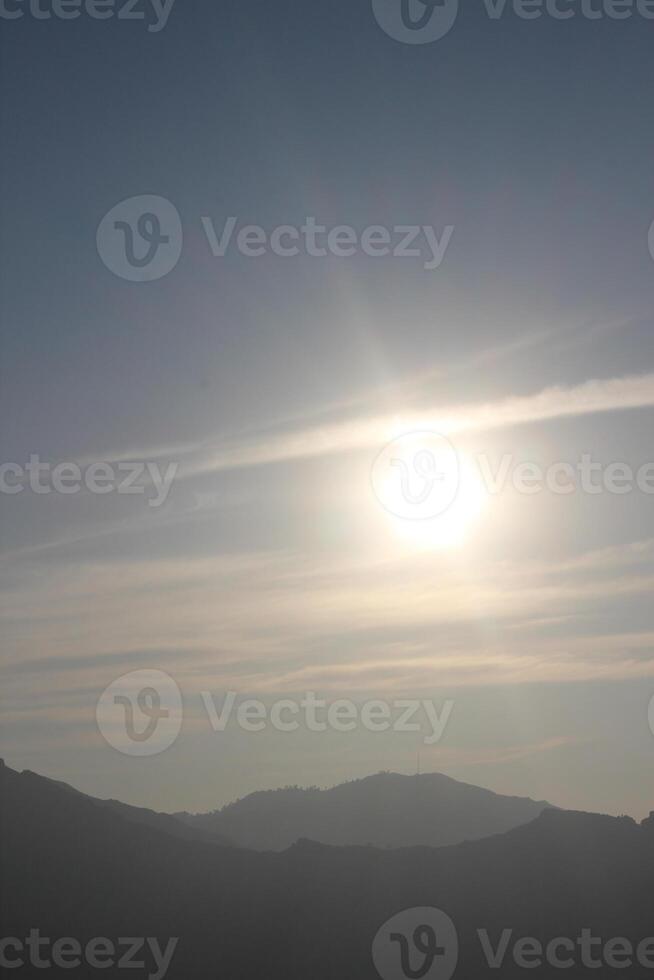 A person flying a kite in the sky photo