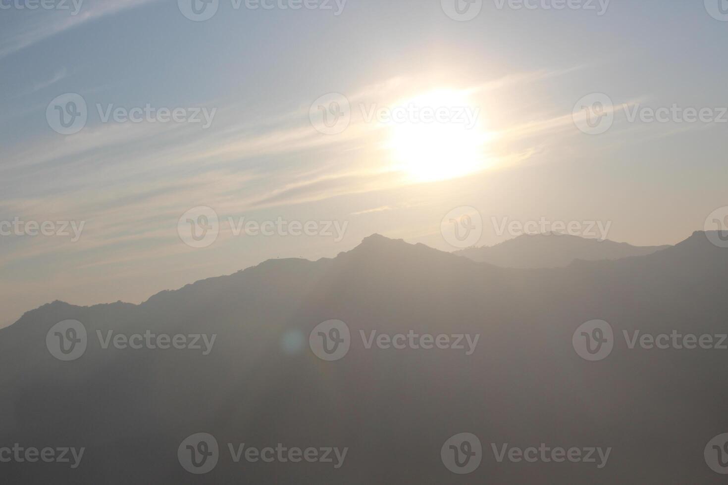 A person is standing on top of a mountain photo