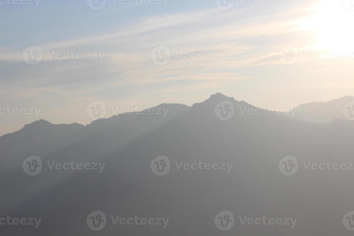 A plane flying over a mountain range photo