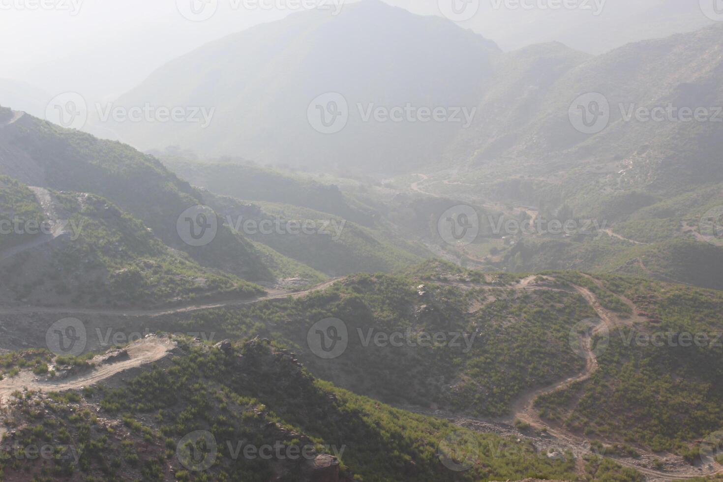A view of a mountain range with a road winding through it photo