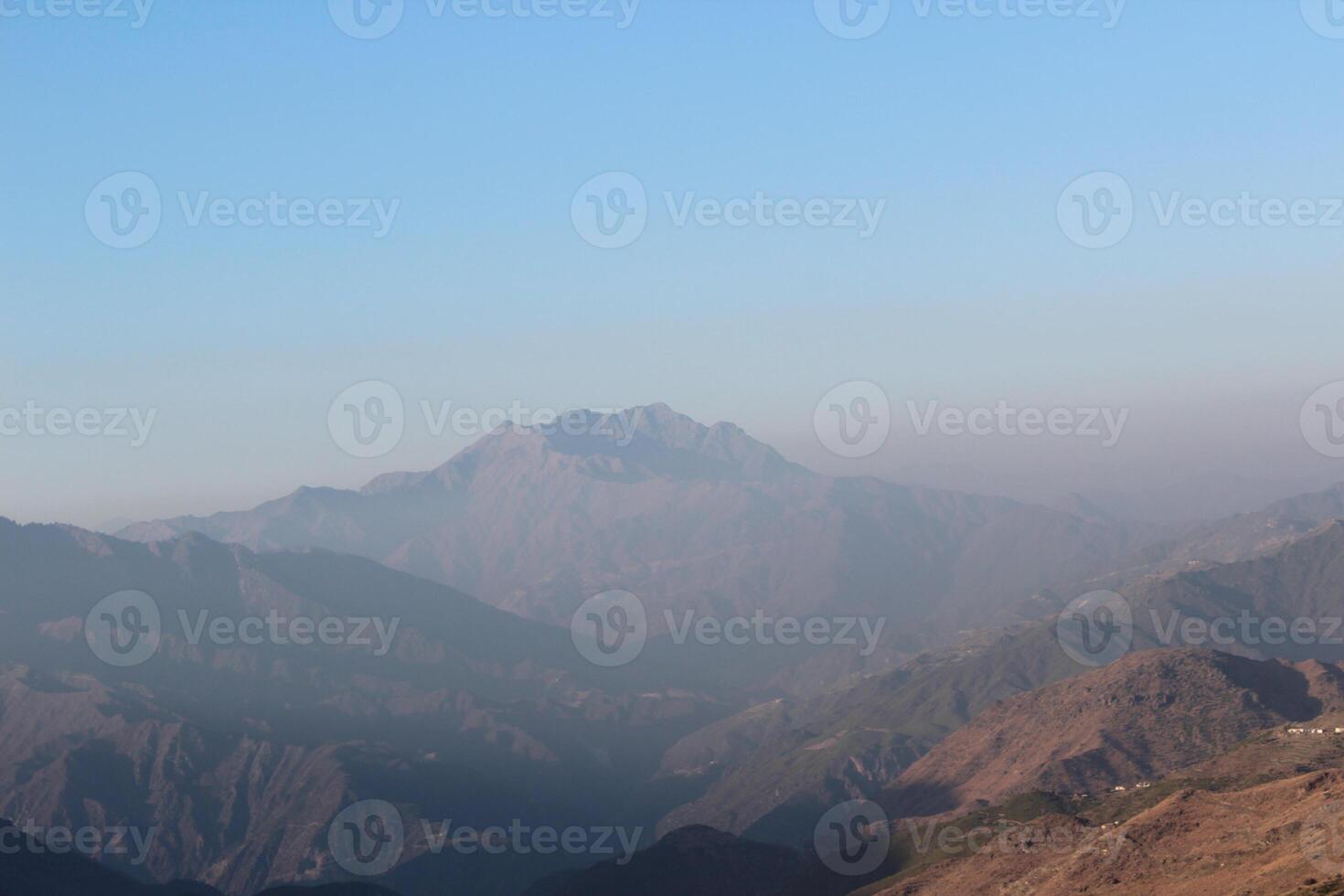 A person standing on a mountain top photo