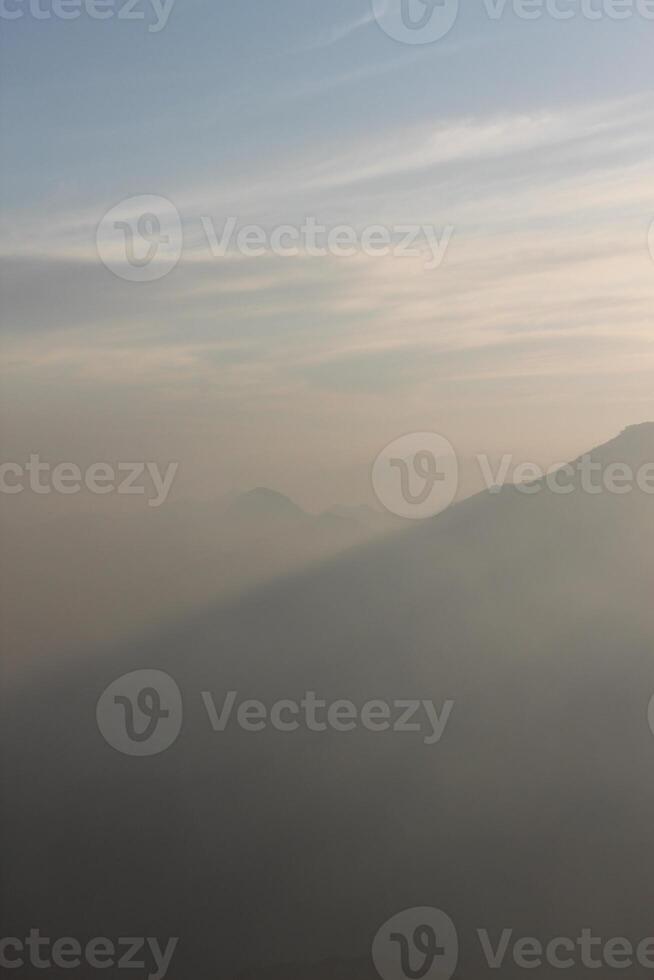 A view of a plane flying over a mountain range photo