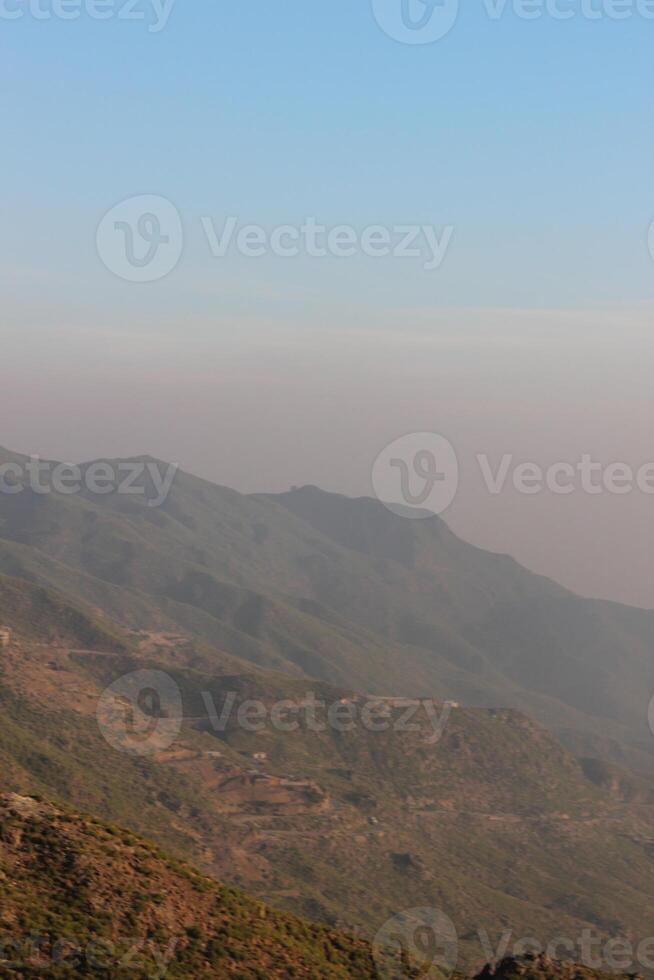 A plane flying over a mountain range photo