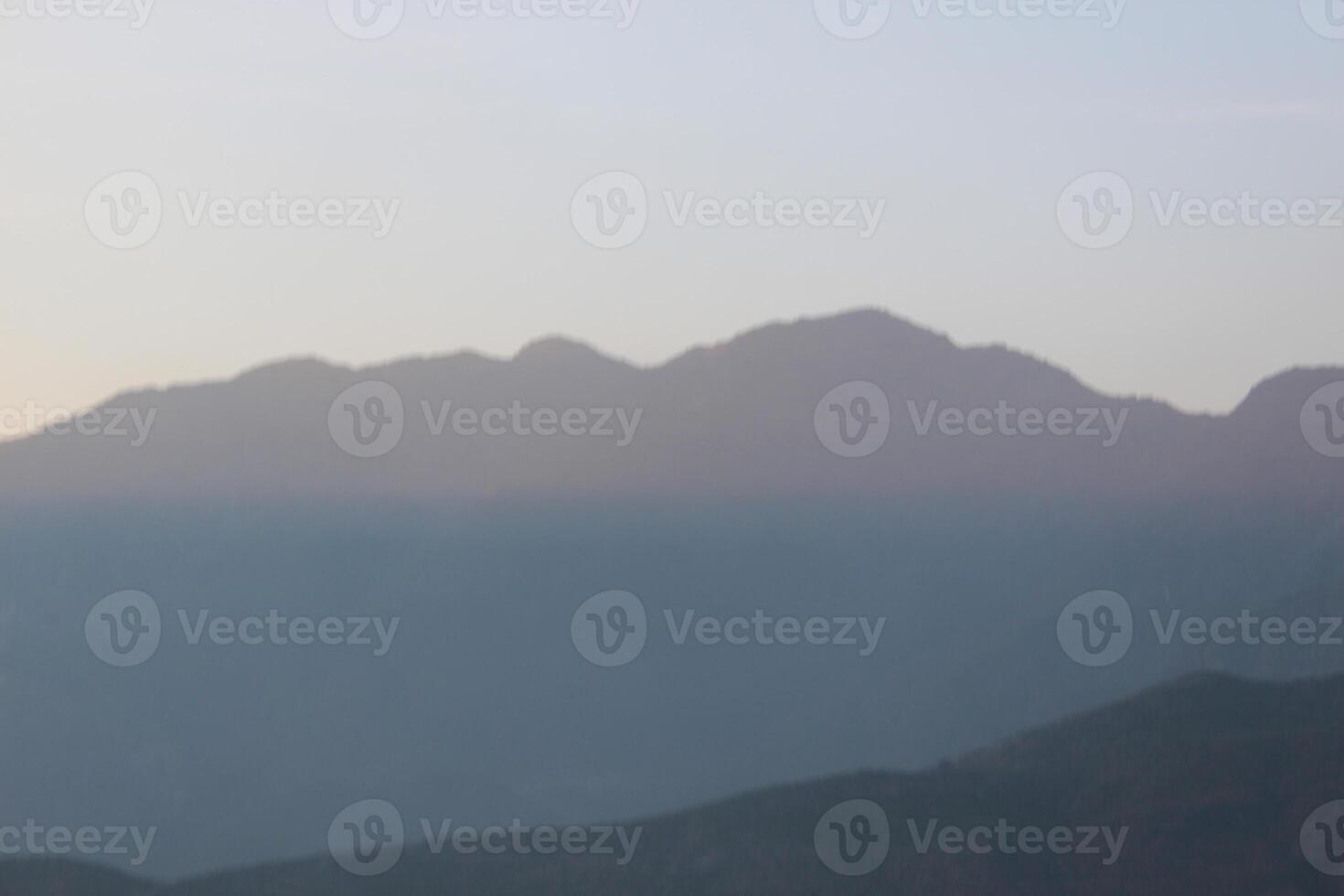 A plane flying over a mountain range photo