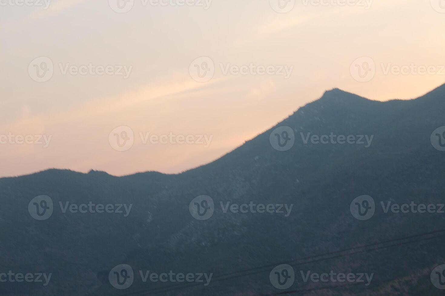 A plane flying over a mountain range photo