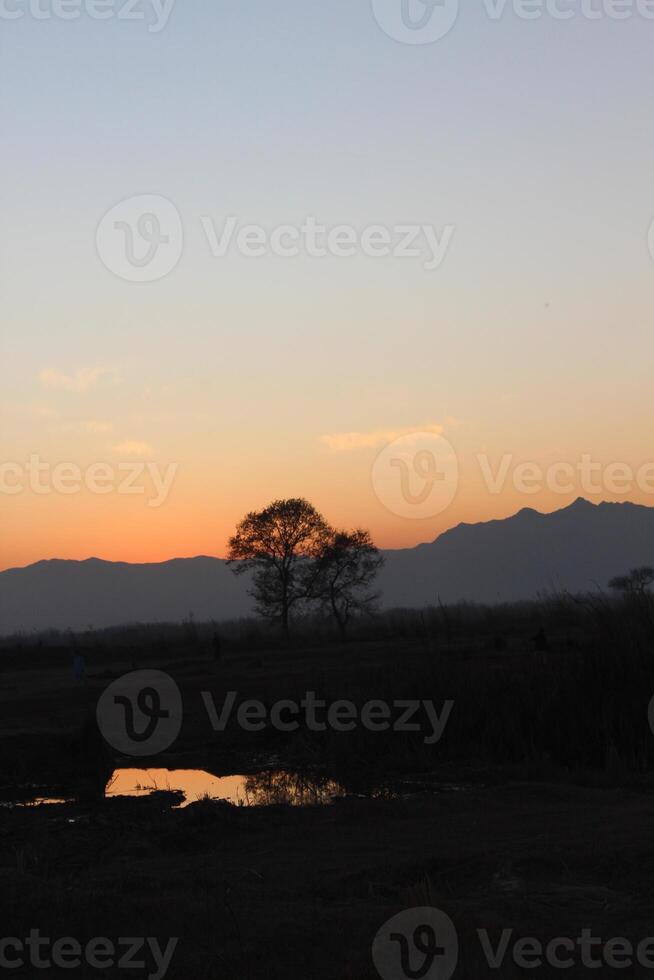A sunset over a lake photo