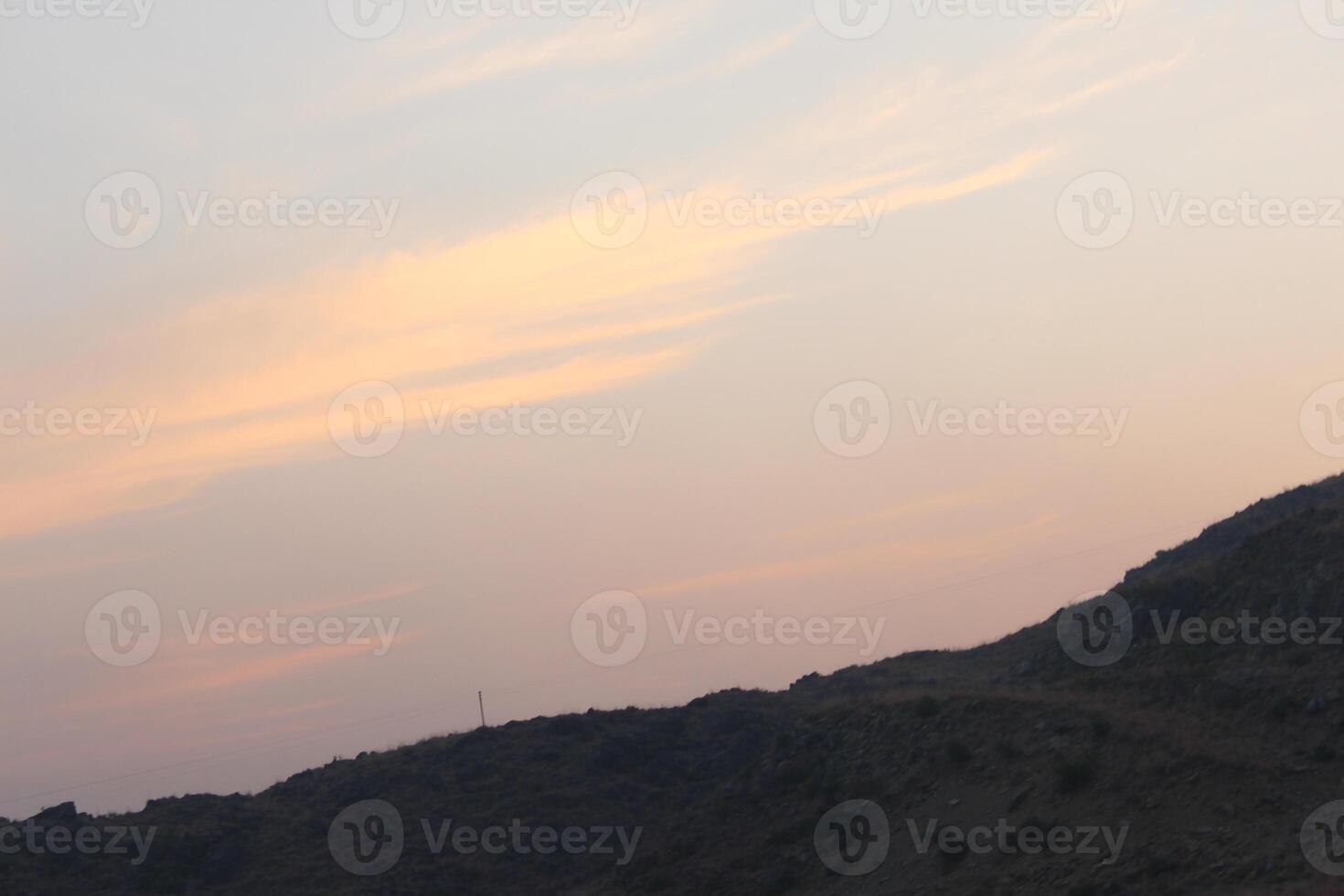 A person flying a kite on a hill photo