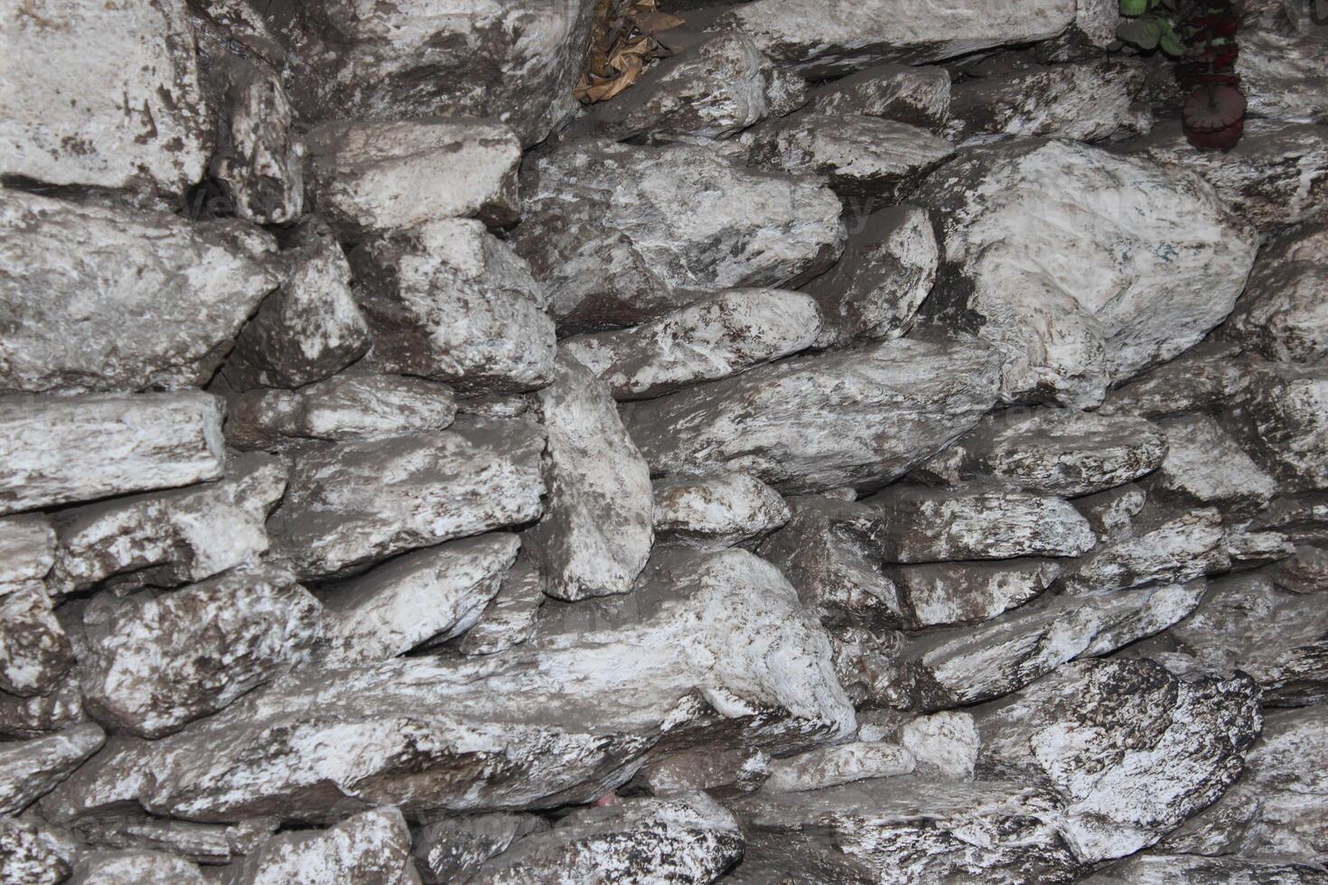 A wall with a large rock formation in it photo