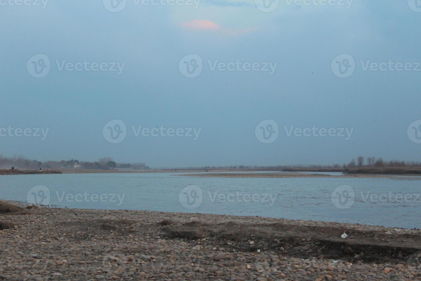 A person standing on a beach with a kite photo