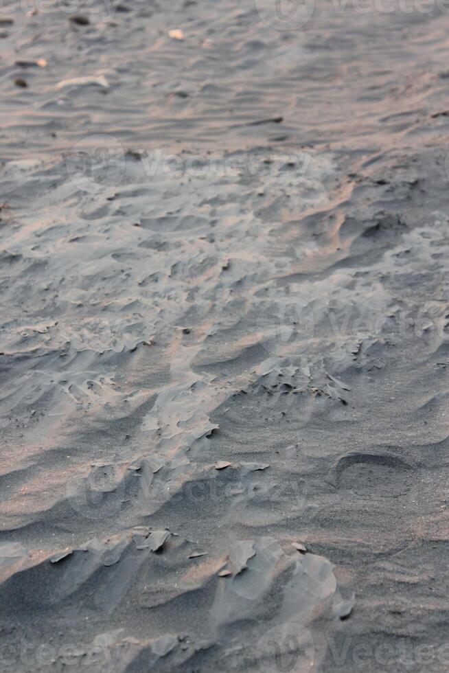 A sand dune with a wave pattern photo