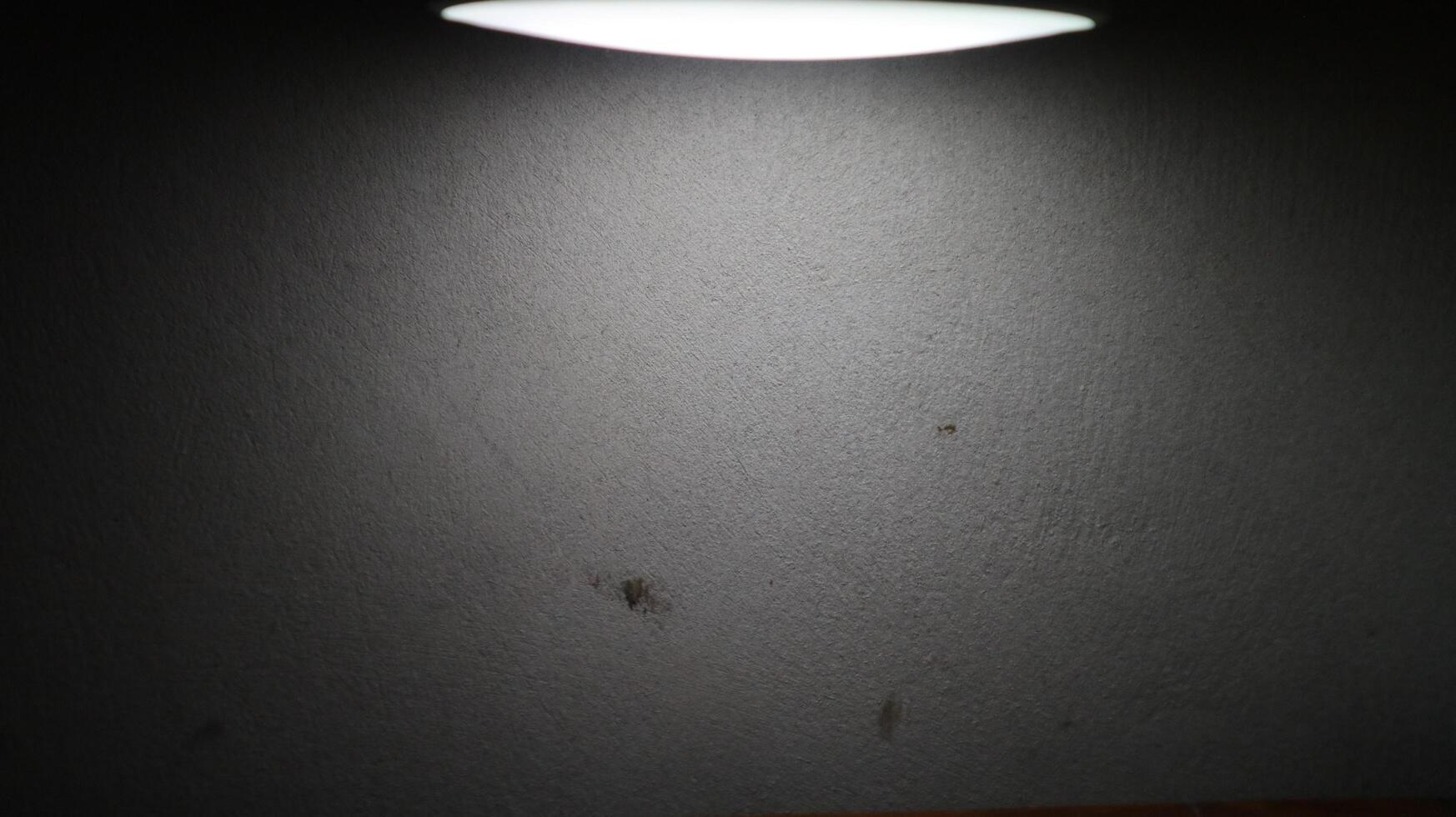 photo of a wall lit from above and producing a silhouette effect