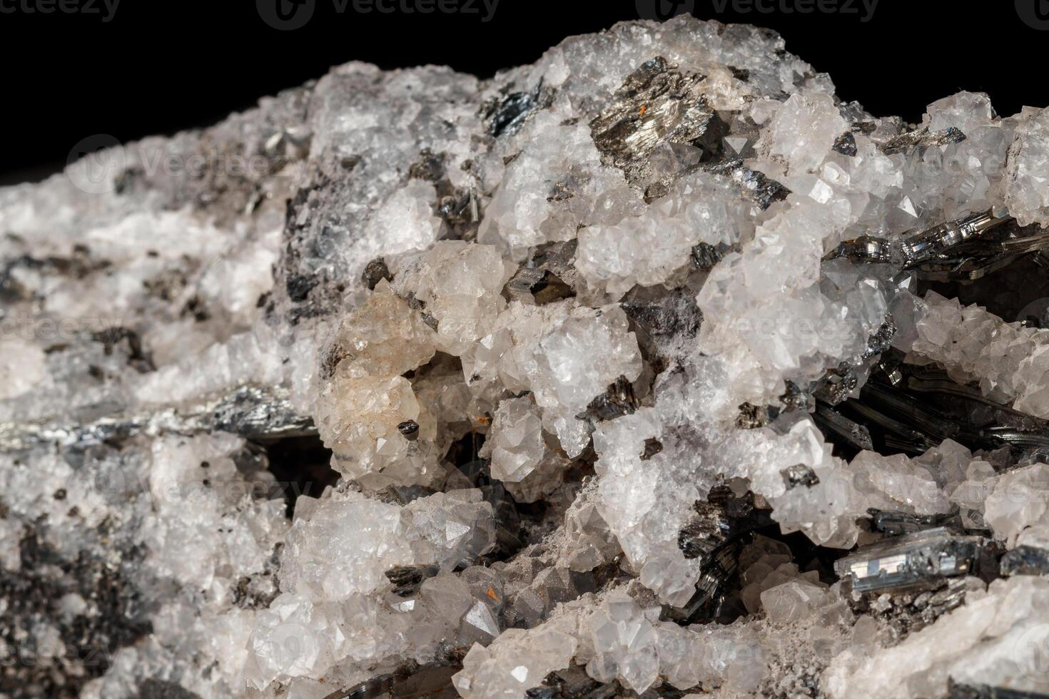 Macro mineral stone Stibnite quartz on a black background close up photo
