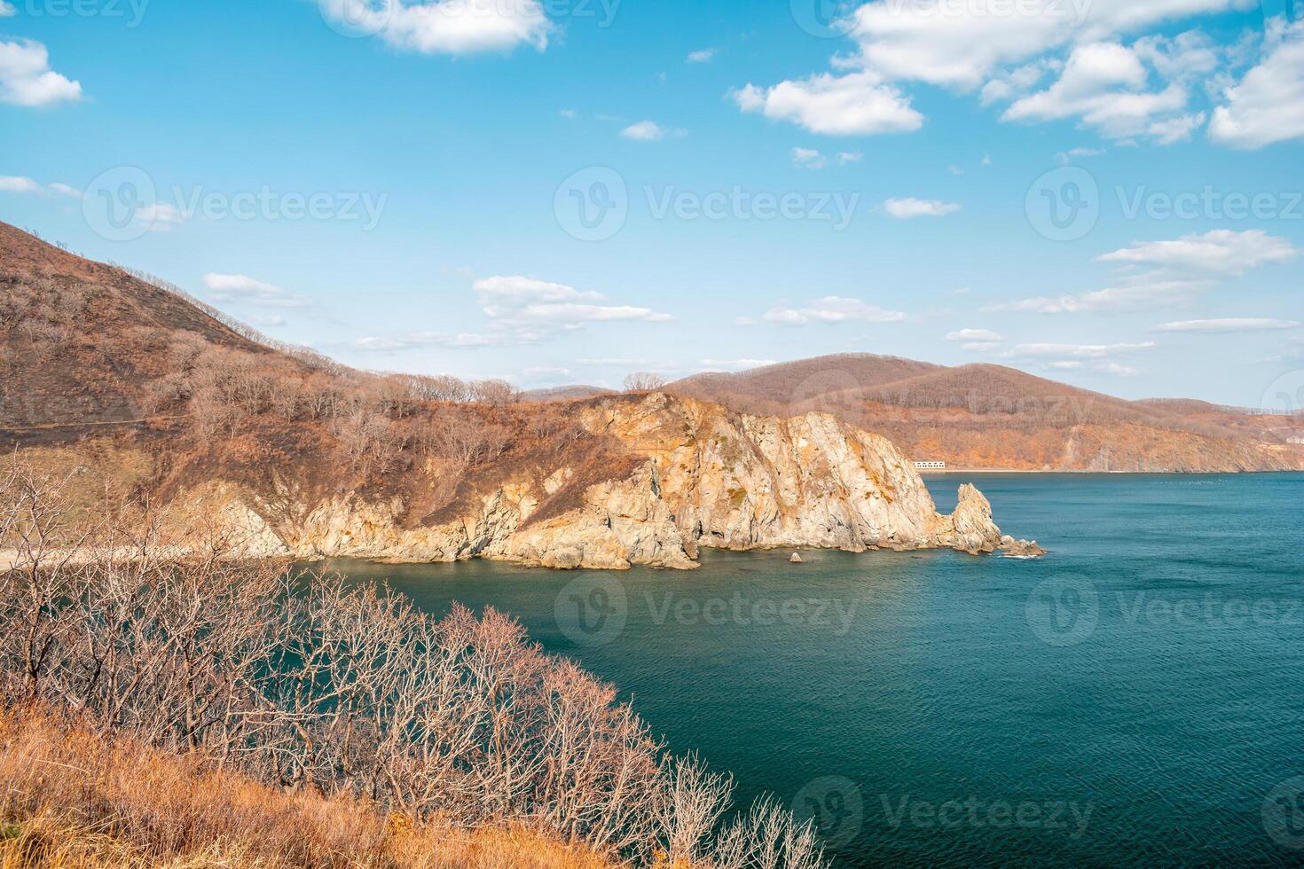 View of the vastness of the Pacific Ocean from th high seashore. High cliffs on the shore of the Pacific Ocean. photo
