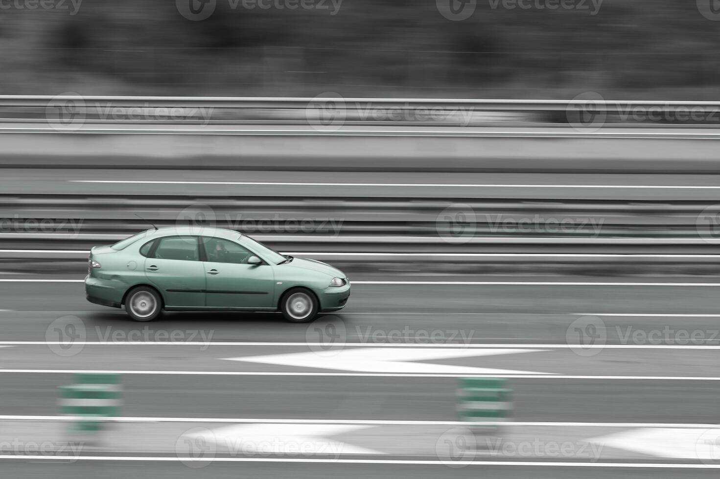 passenger green car on the highway in motion with a blurred background photo