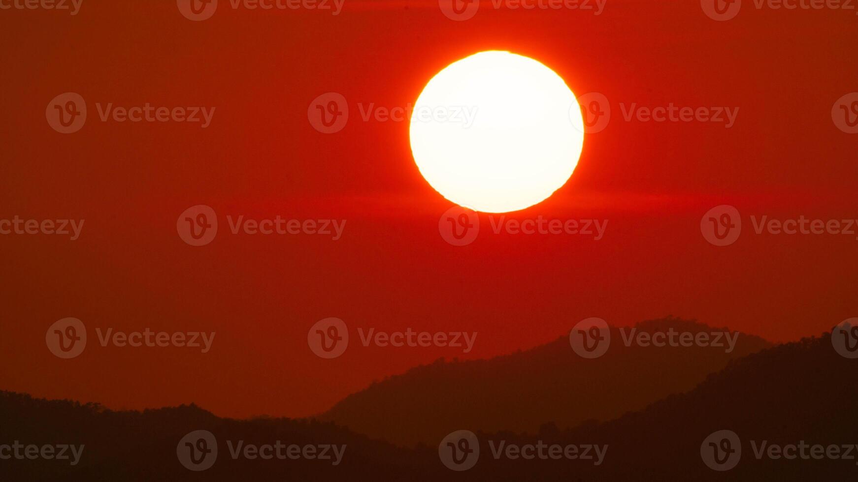 Timelapse shot of a beautiful sunrise over an orange winter sky. Close-up of the sunrise. Morning dawn landscape. photo