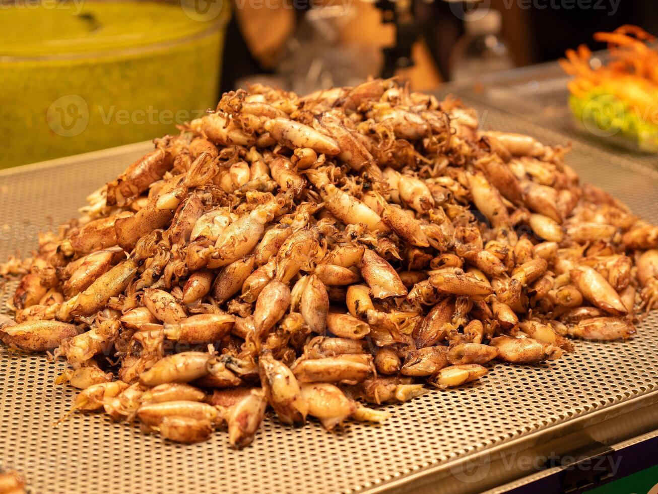 Stir-fried squid stall at the night market Street food in the market of Thailand. photo