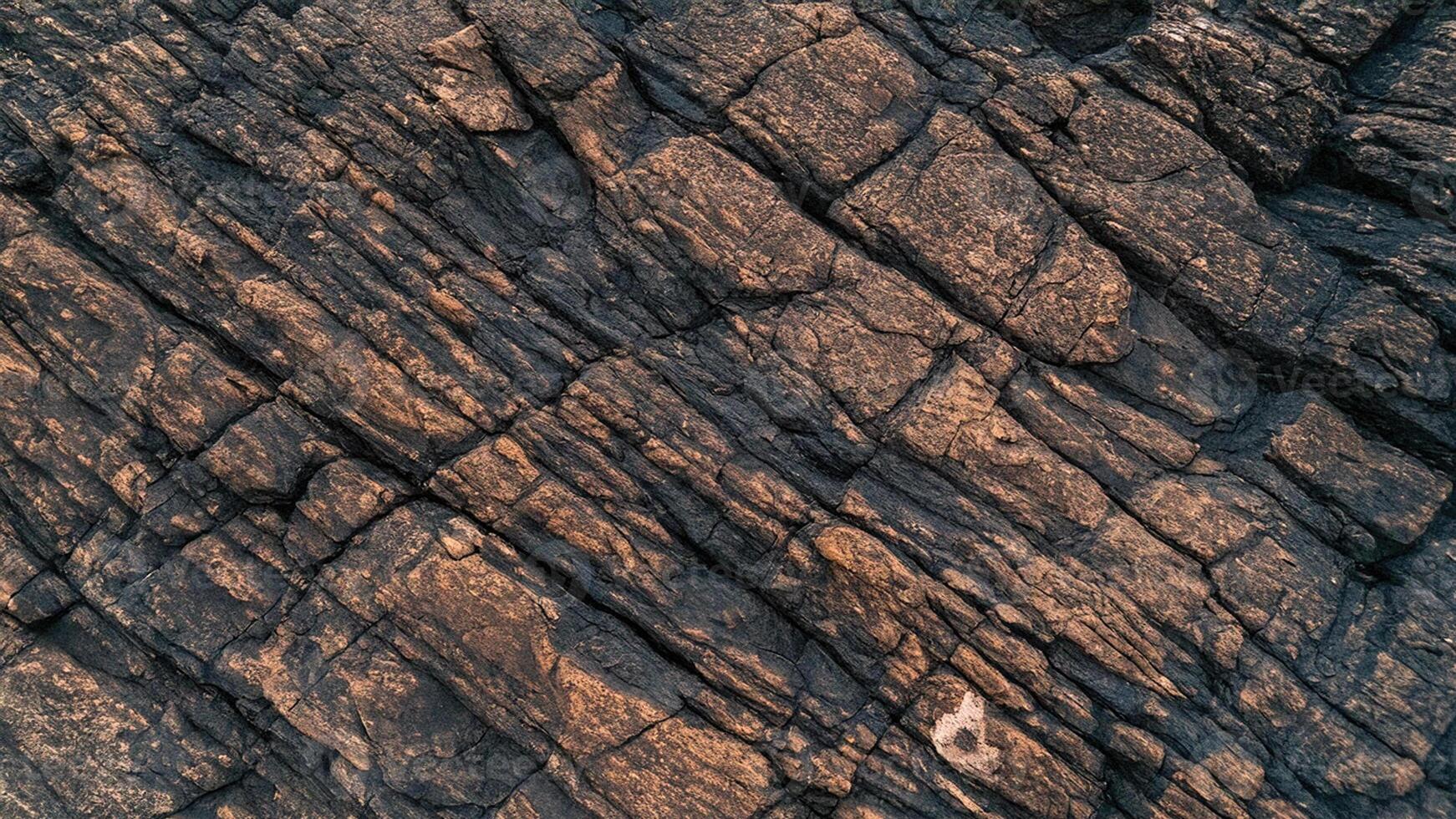 High-resolution textured rocky surface background with deep cracks, ideal for geological design, stone textures, or abstract natural patterns for creative projects. photo