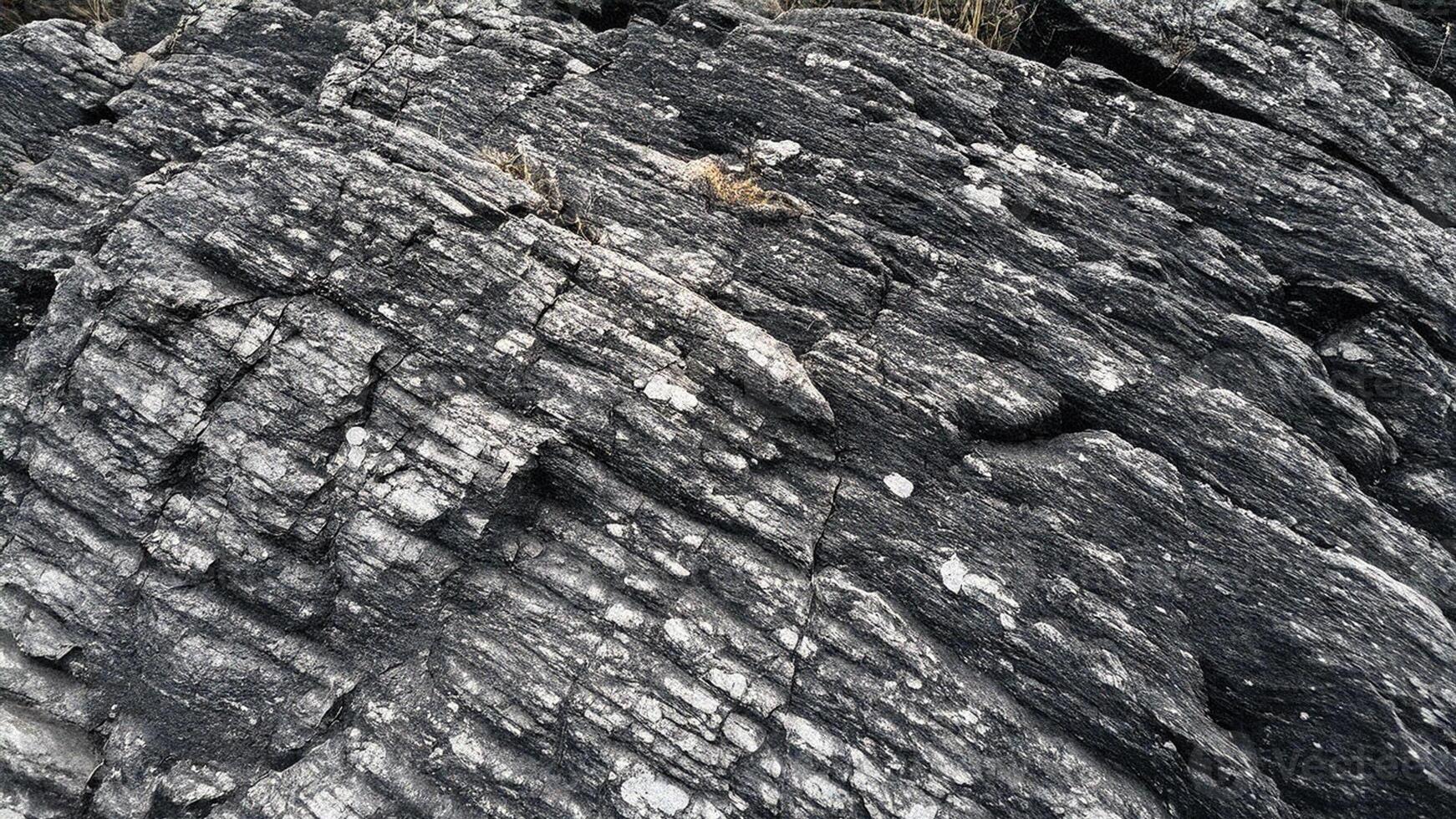 Rough stone texture with linear grooves and intricate patterns, inspired by natural rock formations for geology-themed designs, architecture, and high-resolution stone texture backgrounds photo