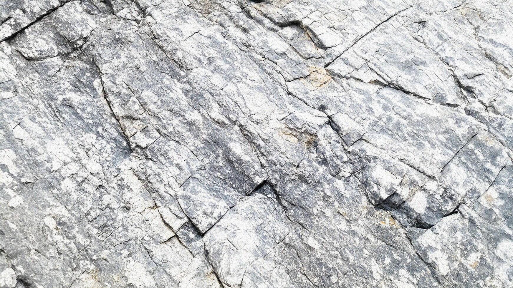 Light stone surface texture with weathered cracks and rough formations, perfect for geological design backgrounds, architectural elements, and outdoor surface patterns photo