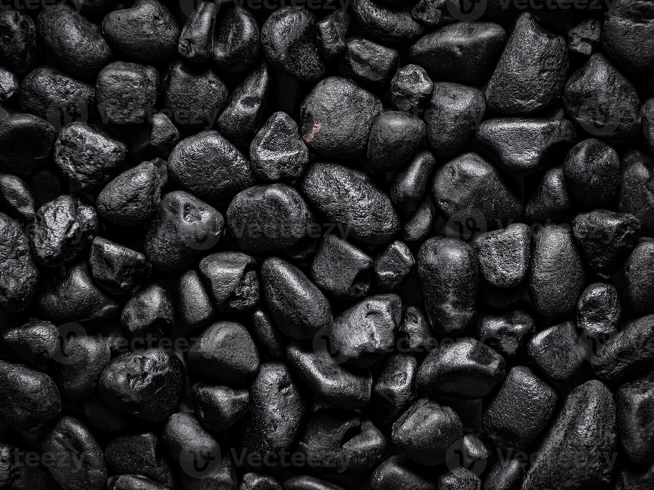 Textured background featuring naturally rounded black stones creates a striking visual effect photo