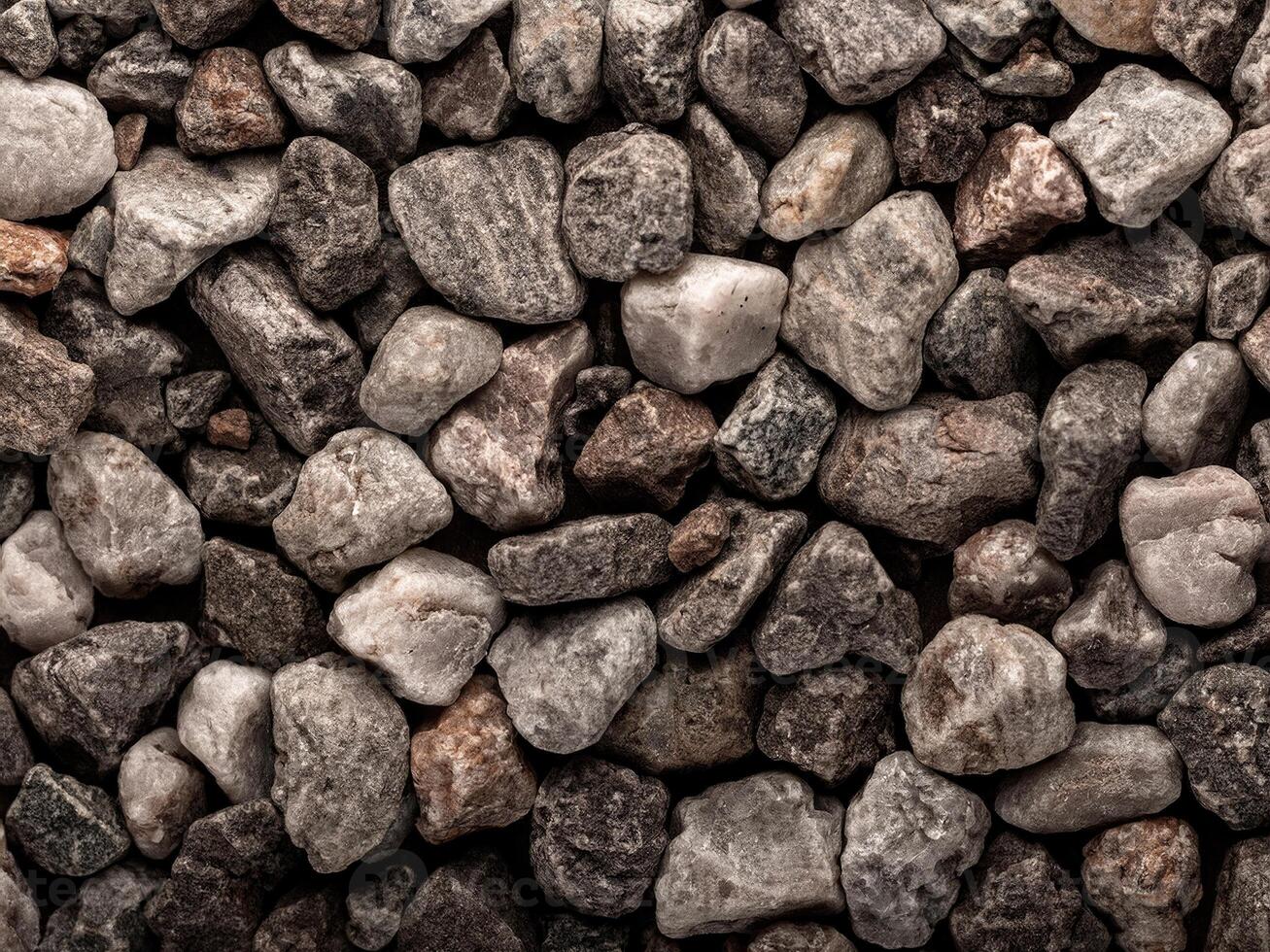 Textured composition of small rocks and pebbles in varied shades of gray and brown photo