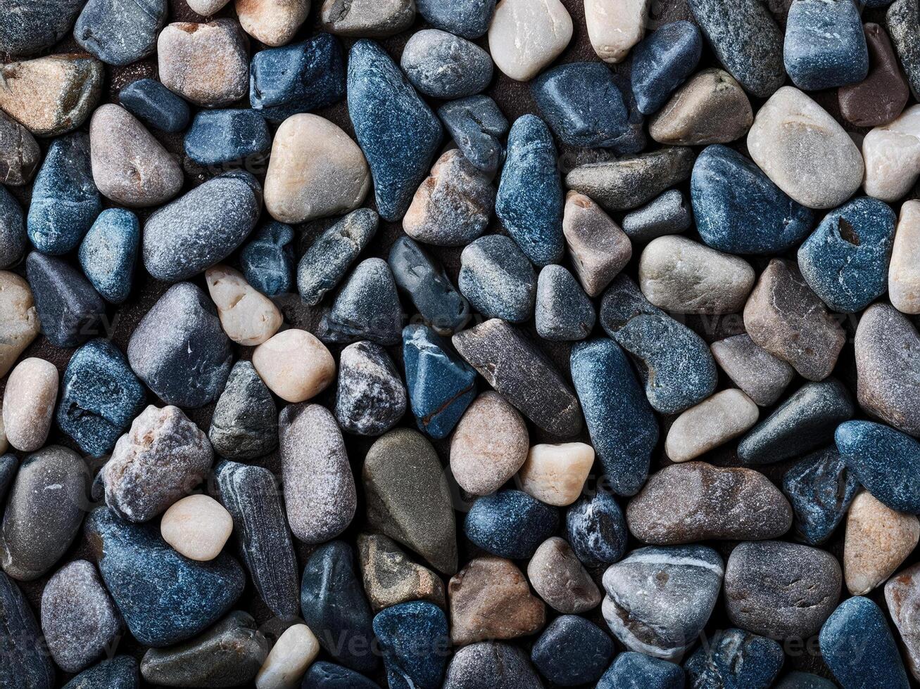 Textured pebbles form an abstract natural background in shades of blue and gray photo