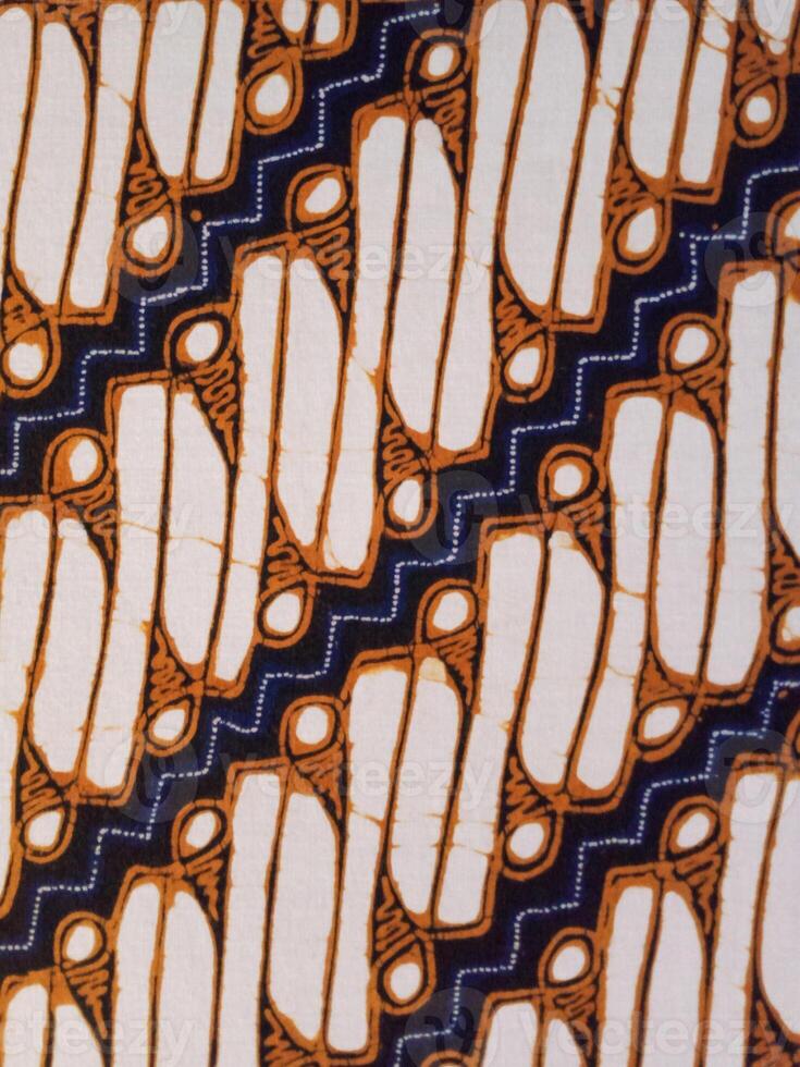 Batik pattern background. A close up of Javanese batik with a Parang Srimpi pattern. Indonesian batik photo