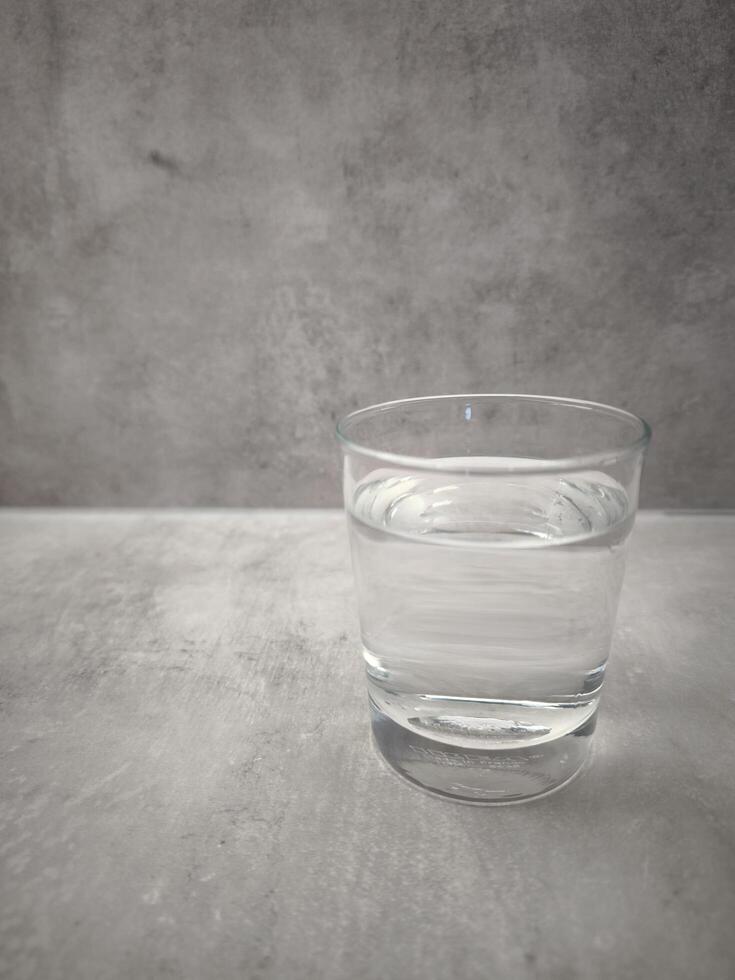 Prague, Czech republic - January 1, 2025. Clear Ikea glass filled with water on a textured surface, in a minimalist style. symbol of health. World Water Day copy space photo