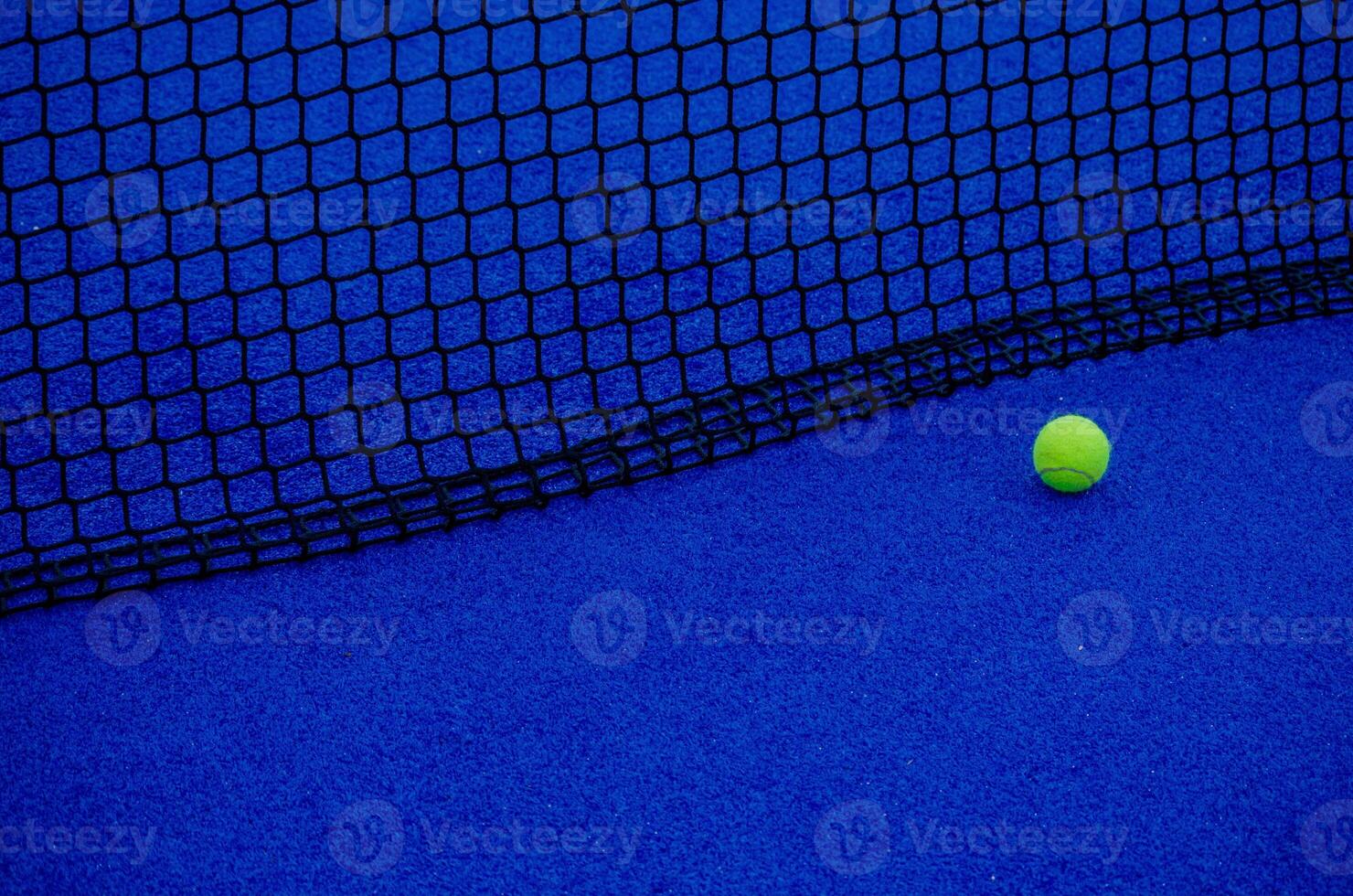 paddle tennis court. isolated ball near the net. photo