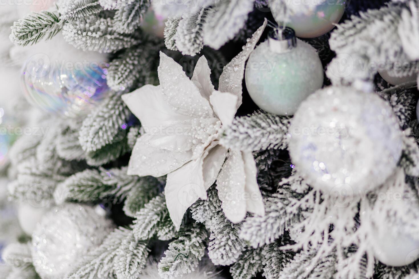 Close-up of Fully Decorated Christmas tree with white, frosted balls.White Ornaments on a Snowy Christmas Tree. Merry Christmas and Happy Holidays, Winter Snow Background. photo