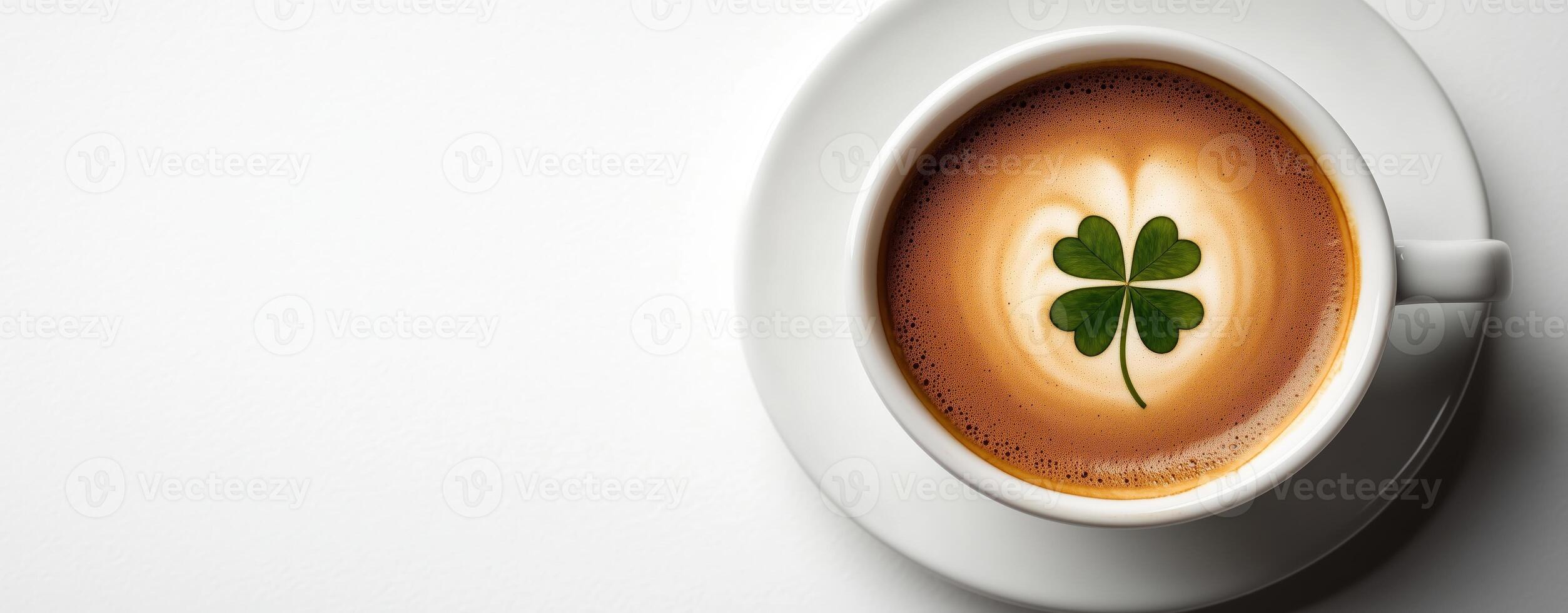 A cup of coffee with a clover leaf on creamy foam, good luck and St. Patrick's Day photo