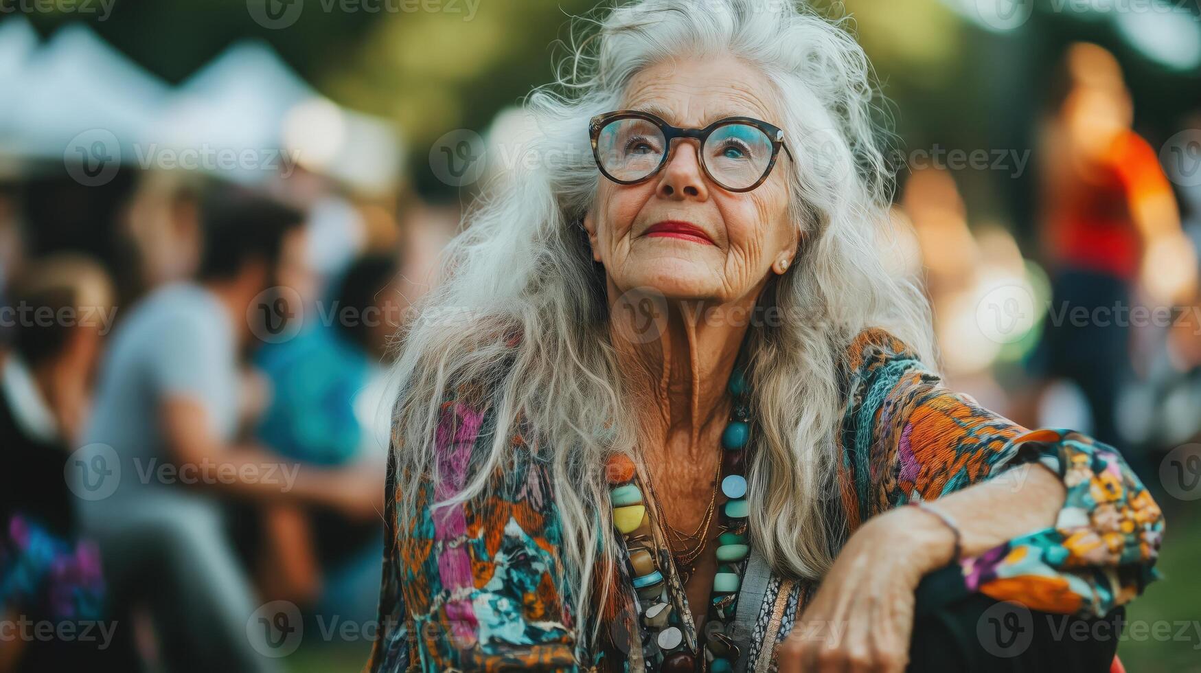 Stylish elderly woman in bohemian attire and sunglasses at an summer music festival photo