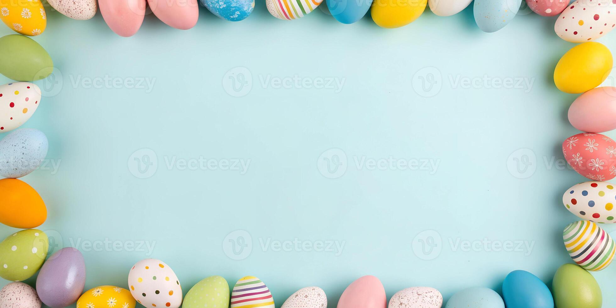 Colorful Easter eggs arranged in a frame on a blue background. Flat lay holiday mockup with copy space photo