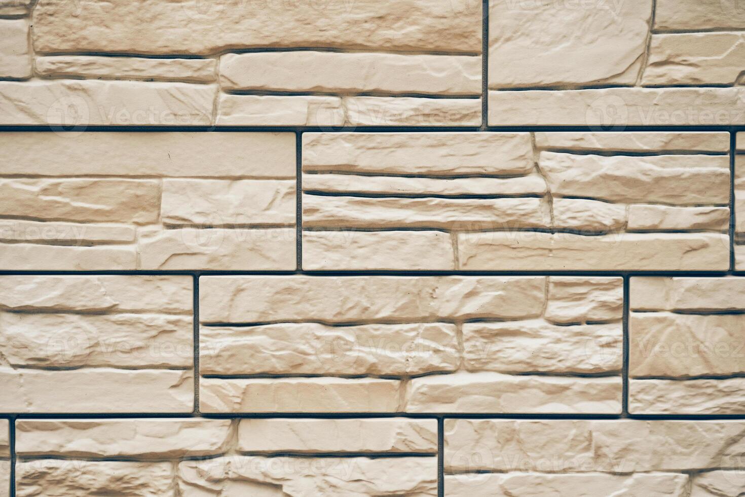 A stone texture with space to copy. Uneven tiles with protruding parts and cracks photo