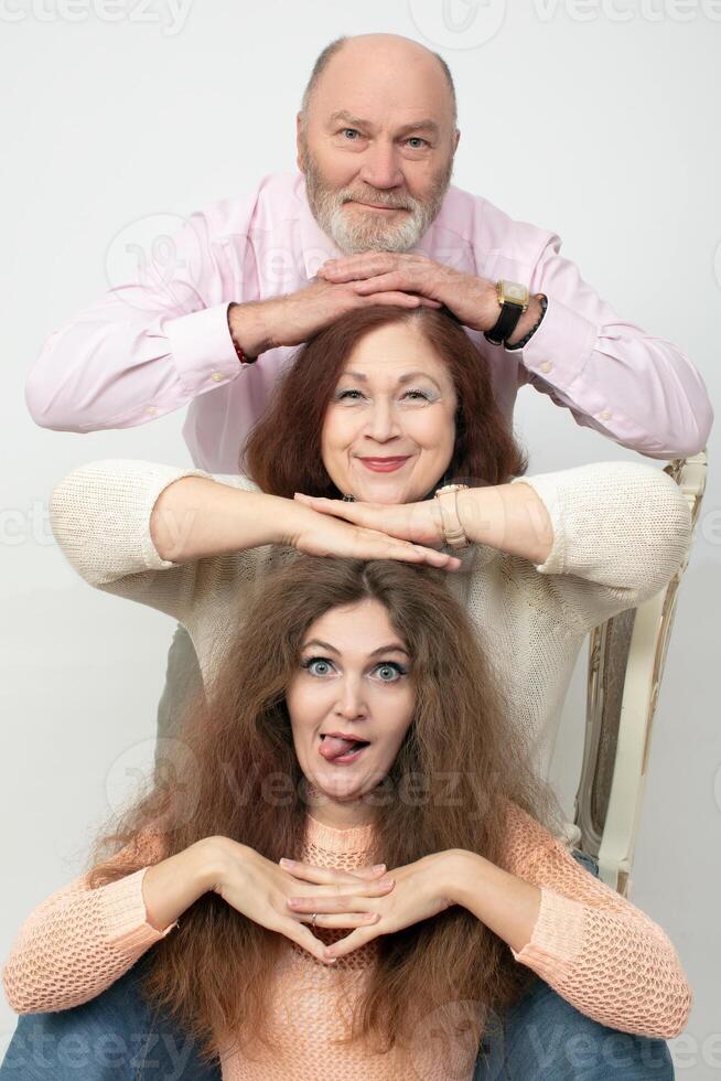A family portrait of elderly parents and an adult daughter photo