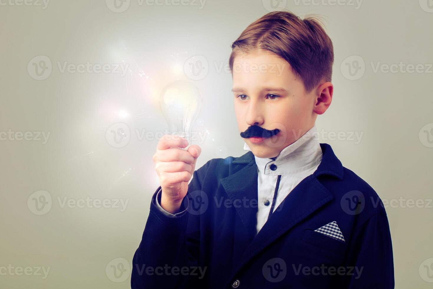 Portrait of a humorous vintage scientist. A child with a false mustache and a light bulb. Success, idea and education. photo