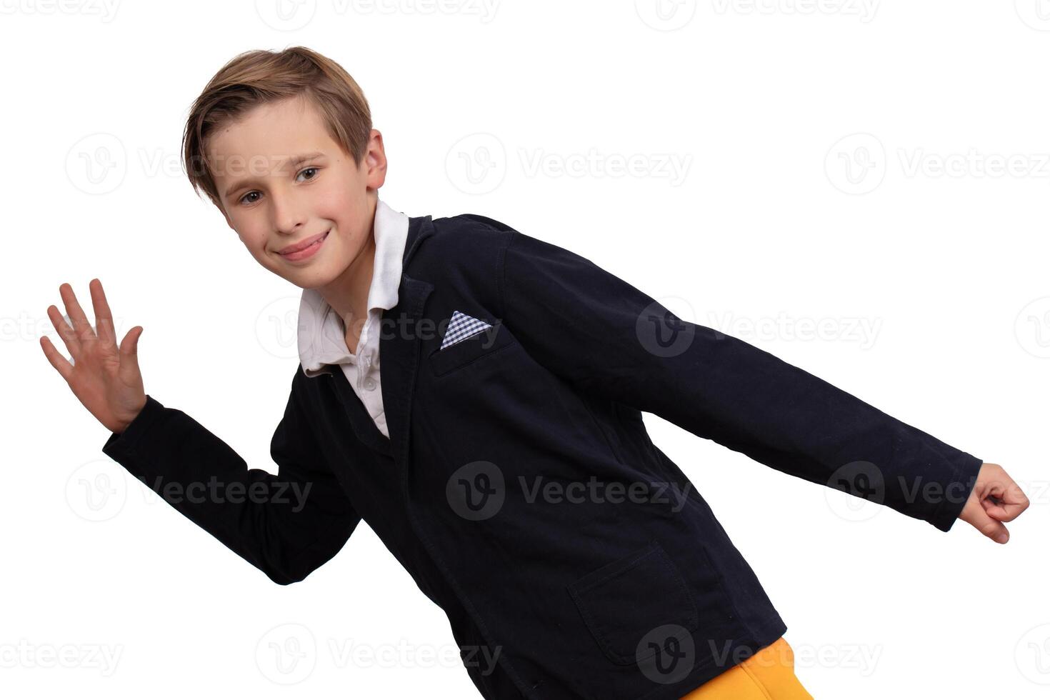 Portrait of a boy who imitates walking on a white background. The student runs and looks at the camera and smiles. photo