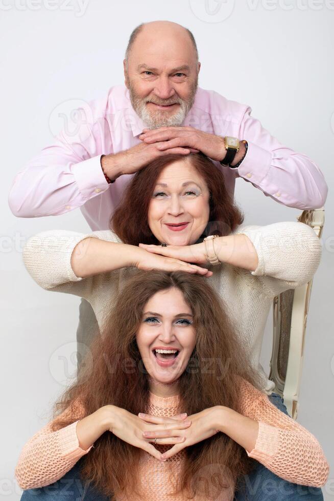 A creative family portrait of elderly parents and an adult daughter photo