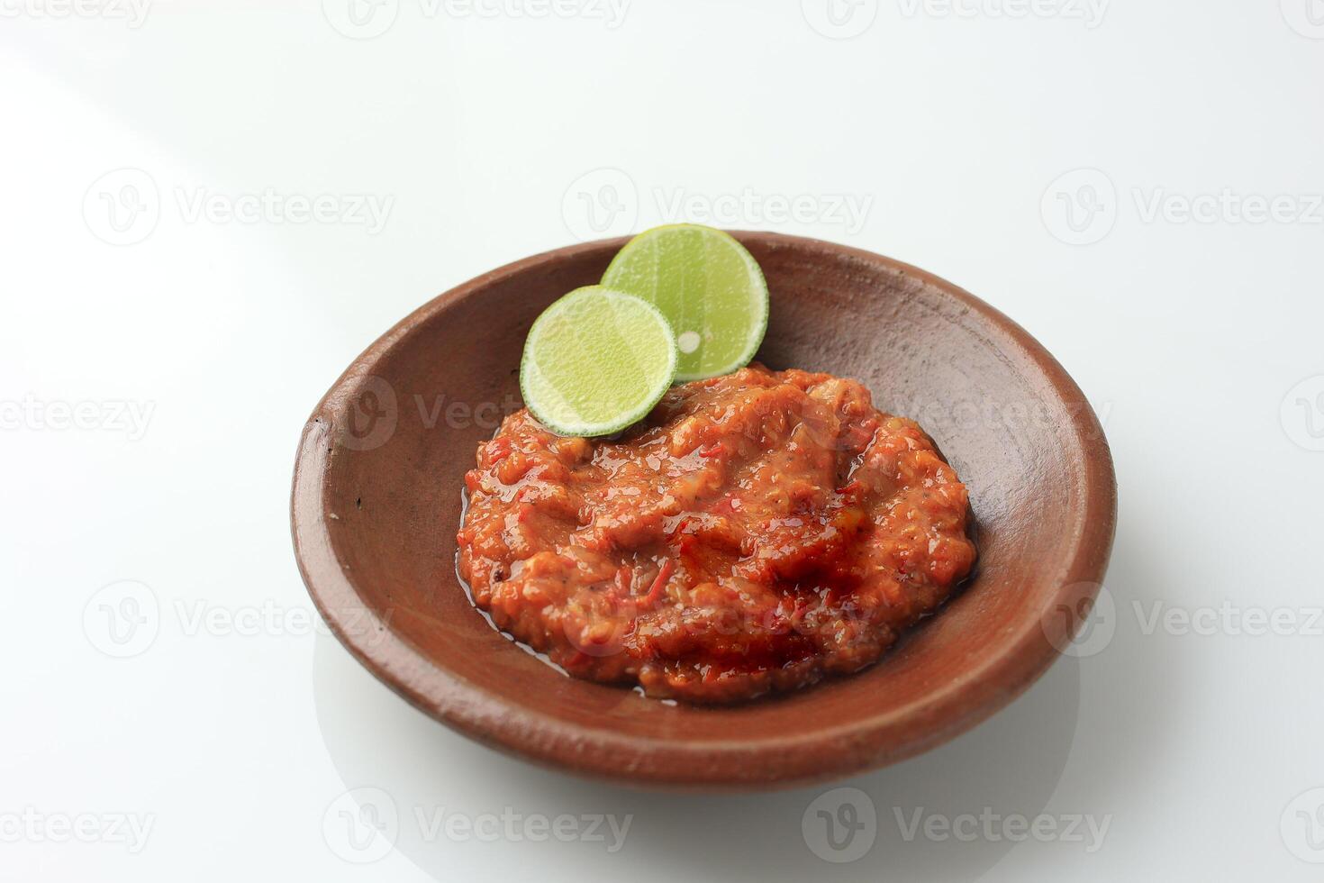 Sambal Tomat or Spicy Tomato Paste on Earthenware Plate photo