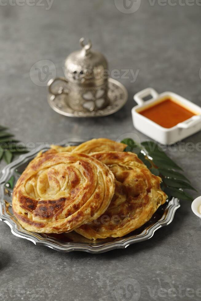 Roti Parata or Roti Canai with Lamb Curry Sauce, Yoghurt and Turkish Tea photo